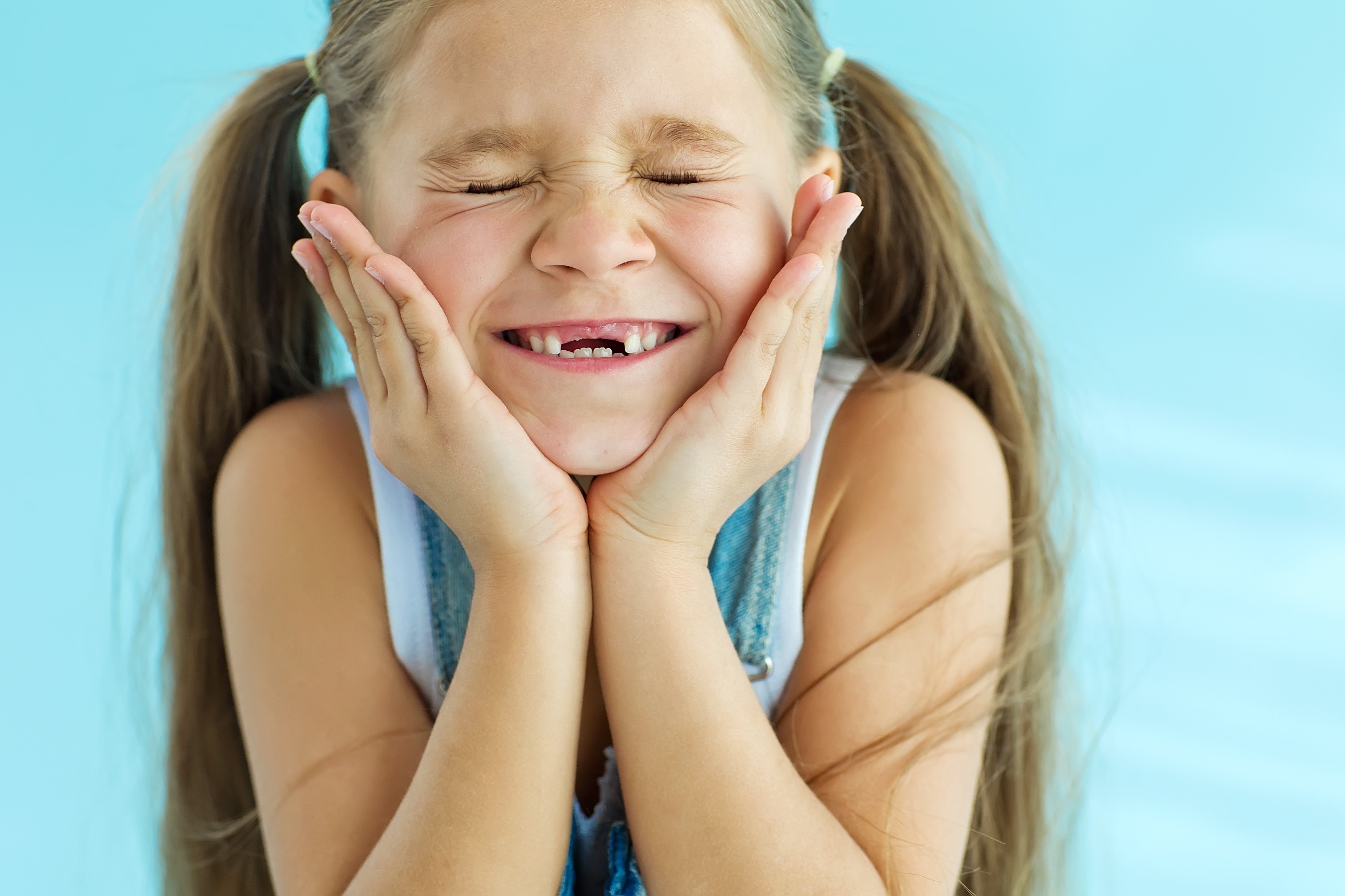 smiling young girl with missing front teeth